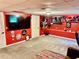 A basement entertainment area with bright red walls and a carpeted floor at 96 Wildwood Dr, Temple, GA 30179