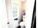 A half bath featuring a window and black and white tiled floors at 96 Wildwood Dr, Temple, GA 30179
