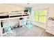 Cozy bedroom featuring a loft bed, vanity area, and large window providing natural light at 96 Wildwood Dr, Temple, GA 30179