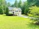 Charming two-story home with a well-manicured lawn, two-car garage, and inviting front entrance surrounded by lush greenery at 96 Wildwood Dr, Temple, GA 30179