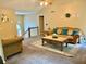Inviting living room with vaulted ceiling, comfortable furnishings, and a staircase leading to the upper level at 96 Wildwood Dr, Temple, GA 30179
