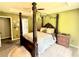 The main bedroom offers an ornate bed frame, neutral walls, and lots of space at 96 Wildwood Dr, Temple, GA 30179