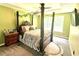 The main bedroom offers an ornate bed frame, neutral walls, and large windows for natural light at 96 Wildwood Dr, Temple, GA 30179