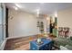 Cozy living room featuring hardwood floors, shelving, and an open-concept design with a kitchen view at 1195 Milton Se Ter # 2203, Atlanta, GA 30315