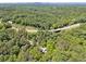 An aerial perspective of a home with green surroundings and nearby roads at 13795 Arnold Mill Rd, Roswell, GA 30075
