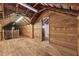 Unfinished attic space with wooden beams and flooring, offering potential for customization at 13795 Arnold Mill Rd, Roswell, GA 30075
