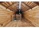 Long unfinished attic space with wooden beams and flooring, offering potential for customization at 13795 Arnold Mill Rd, Roswell, GA 30075