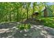 Backyard featuring a stone patio, stairway to the home, and a natural, wooded setting at 13795 Arnold Mill Rd, Roswell, GA 30075