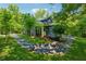 Charming blue house with a stone walkway, lush lawn, and mature trees surrounding the property at 13795 Arnold Mill Rd, Roswell, GA 30075