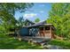 Spacious backyard featuring a wooden porch and a large stone patio, perfect for outdoor entertaining at 13795 Arnold Mill Rd, Roswell, GA 30075