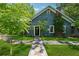 Charming blue house with a stone pathway leading to the front door and lush green lawn at 13795 Arnold Mill Rd, Roswell, GA 30075