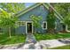 Charming blue house with a stone pathway and manicured lawn, offering inviting curb appeal at 13795 Arnold Mill Rd, Roswell, GA 30075