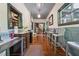 Spacious hallway with hardwood floors, wainscoting, and a glimpse of the staircase at 13795 Arnold Mill Rd, Roswell, GA 30075