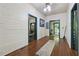 Inviting hallway with wood floors and trim features neutral walls and access to other rooms at 13795 Arnold Mill Rd, Roswell, GA 30075