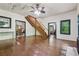 Spacious living room featuring wood staircase and plenty of natural light from the windows at 13795 Arnold Mill Rd, Roswell, GA 30075