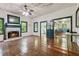 Charming living room with hardwood floors, fireplace, and vintage-style ceiling fan at 13795 Arnold Mill Rd, Roswell, GA 30075