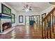 Inviting living room with fireplace, windows and a glimpse of other rooms in the house at 13795 Arnold Mill Rd, Roswell, GA 30075