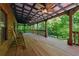 Spacious covered porch with rocking chairs, ideal for enjoying the outdoor scenery at 13795 Arnold Mill Rd, Roswell, GA 30075