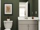Stylish bathroom boasting a gray vanity, framed art, and olive green walls, creating a cozy and modern ambiance at 2322 Treaty Ln, Douglasville, GA 30135