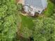An aerial view of a home with a spacious backyard, multi-level deck, and surrounded by mature trees at 25 Grange Ct, Sharpsburg, GA 30277