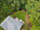 Aerial view of a well-maintained home with a large, fenced backyard, deck, and lush surrounding trees at 25 Grange Ct, Sharpsburg, GA 30277