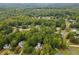 Aerial view showcasing a residential neighborhood with lush greenery and well-maintained homes at 25 Grange Ct, Sharpsburg, GA 30277