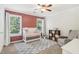 Bedroom with crib and gray chair, featuring two windows for a naturally bright room at 25 Grange Ct, Sharpsburg, GA 30277