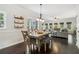 Open-concept dining area with a dining table and chairs, with hardwood floors and views into the living room at 25 Grange Ct, Sharpsburg, GA 30277