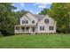 Charming two-story home with a spacious front yard and inviting covered porch at 25 Grange Ct, Sharpsburg, GA 30277