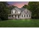 Charming two-story home with a spacious front yard and inviting covered porch at 25 Grange Ct, Sharpsburg, GA 30277
