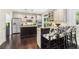 Eat-in kitchen featuring stainless steel appliances, granite countertops, a black island, and bar seating at 25 Grange Ct, Sharpsburg, GA 30277