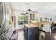 Eat-in kitchen features stainless steel appliances, an island with a sink, granite countertops, and dark hardwood floors at 25 Grange Ct, Sharpsburg, GA 30277