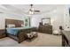 The main bedroom featuring a tray ceiling, ceiling fan, and a dark wood bedroom set at 25 Grange Ct, Sharpsburg, GA 30277
