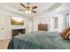 Spacious main bedroom featuring a tray ceiling, fireplace, large television, and a view to the bathroom at 25 Grange Ct, Sharpsburg, GA 30277