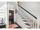 Elegant staircase with white spindles and dark wood accents at 25 Grange Ct, Sharpsburg, GA 30277
