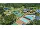 Scenic aerial view of community amenities: golf course, tennis courts, pool, clubhouse and parking at 3145 Indian Hills Ne Dr, Marietta, GA 30068