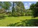 Lush green backyard featuring mature trees, providing privacy and a serene outdoor space at 3145 Indian Hills Ne Dr, Marietta, GA 30068