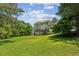 Expansive green backyard with a deck showcasing a serene setting and lots of space at 3145 Indian Hills Ne Dr, Marietta, GA 30068