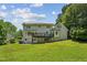 Expansive backyard view showcasing a deck, lush lawn and mature trees, offering a private outdoor space at 3145 Indian Hills Ne Dr, Marietta, GA 30068