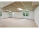 Spacious basement features neutral walls and carpet, natural light, and access to the outdoors at 3145 Indian Hills Ne Dr, Marietta, GA 30068