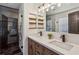 Modern bathroom features a dual sink vanity, wood accents, and tiled shower with glass door at 3145 Indian Hills Ne Dr, Marietta, GA 30068