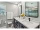 Bathroom features a dual sink vanity with modern fixtures and a shower with a blue patterned shower curtain at 3145 Indian Hills Ne Dr, Marietta, GA 30068