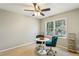 Bright bedroom with neutral walls, ceiling fan, large window, and teal upholstered chairs at 3145 Indian Hills Ne Dr, Marietta, GA 30068