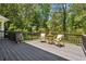 Outdoor deck area features a table and chairs for relaxing with a view of the green back yard at 3145 Indian Hills Ne Dr, Marietta, GA 30068