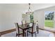 Dining room featuring a modern chandelier, hardwood floors, and a scenic window view at 3145 Indian Hills Ne Dr, Marietta, GA 30068