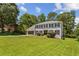 Traditional two-story home featuring a well-manicured lawn and a charming front exterior with attached garage at 3145 Indian Hills Ne Dr, Marietta, GA 30068