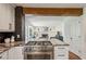 Granite countertops and stainless gas range highlighted in open concept kitchen at 3145 Indian Hills Ne Dr, Marietta, GA 30068