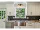 Charming kitchen is accented by black tile and features updated sink fixtures at 3145 Indian Hills Ne Dr, Marietta, GA 30068