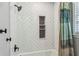 Shower includes modern fixtures, white subway tile with black mosaic niche, and patterned shower curtain at 3145 Indian Hills Ne Dr, Marietta, GA 30068