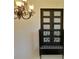 Interior balcony with iron railing and transom windows, framed by an ornate iron chandelier at 4590 River Stone Trl, Douglasville, GA 30135